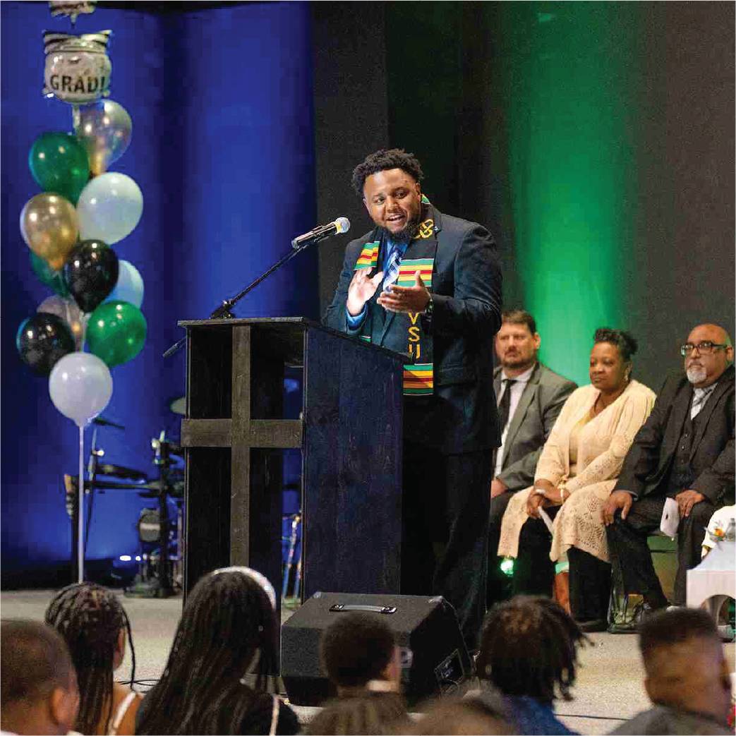 Barry Hall, assistant director of charter through college programs, tells the audience at Timberland Charter Academy about the pipeline program June 2 during an eighth grade promotion ceremony.